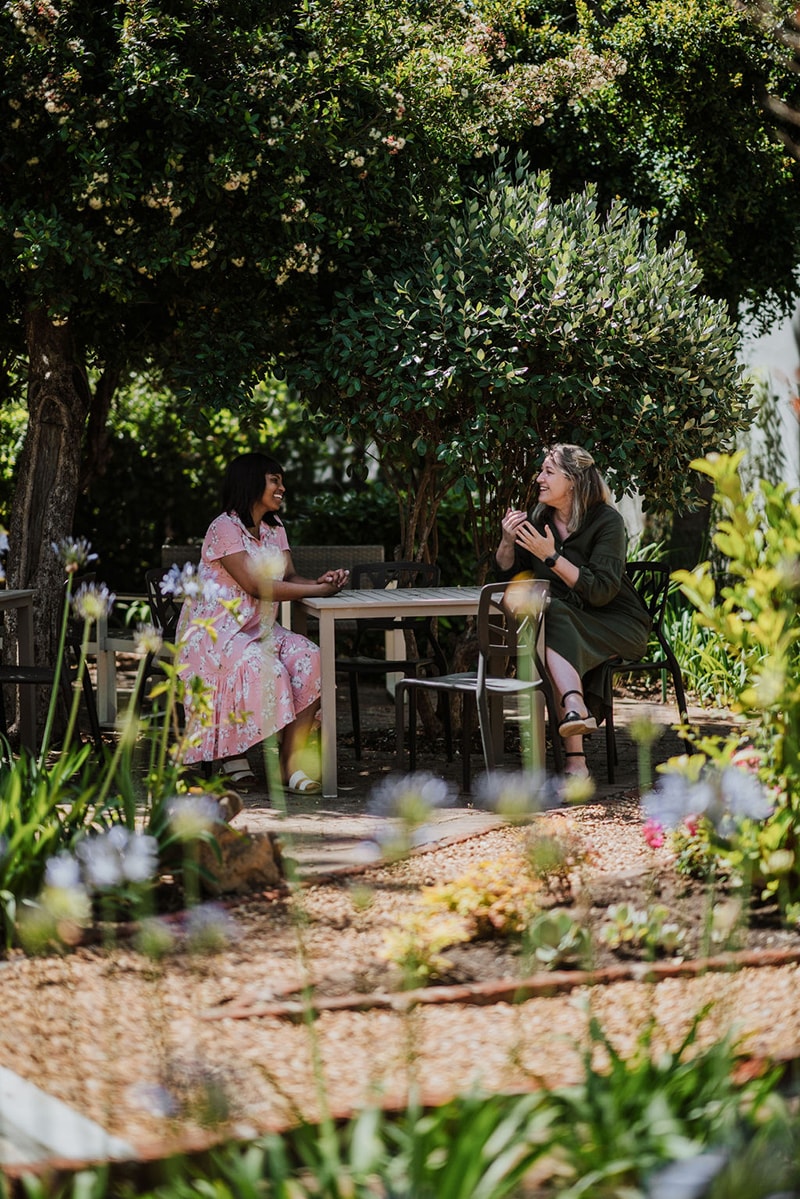 Women talking in a beautiful garden